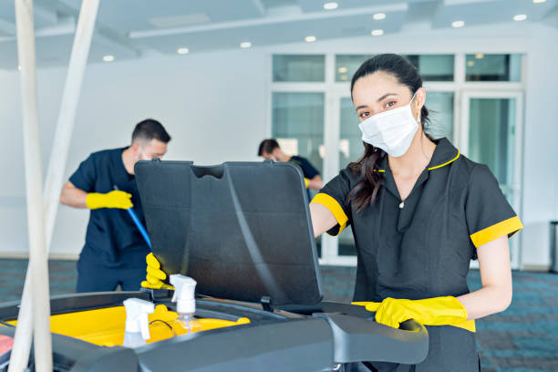 istock Three hotel cleaners cleaning common areas with their masks on. 1280984301