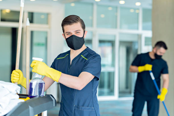 istock Three hotel cleaners cleaning common areas with their masks on. 1280984369