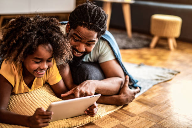 istock Father and daughter using digital tablet at home. 1280984409