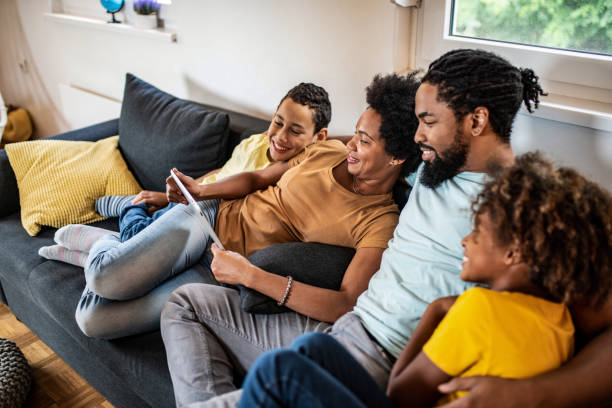istock Happy African American family using digital tablet. 1280985157