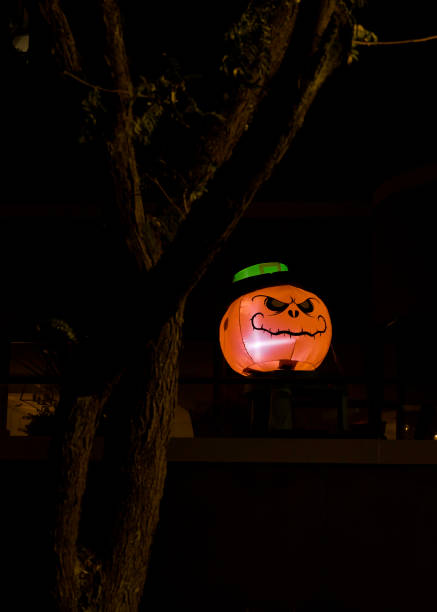 istock Inflatable Halloween pumpkin sitting on a wall 1280985404