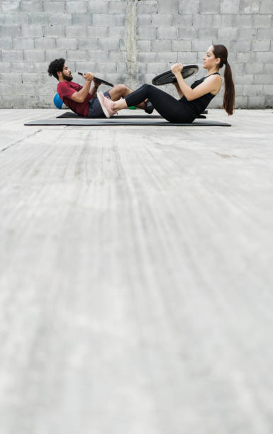 istock Latin couple cross training with weights at home 1280986840