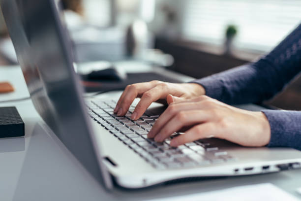 istock Women's hands on a laptop keyboard close-up 1280987575
