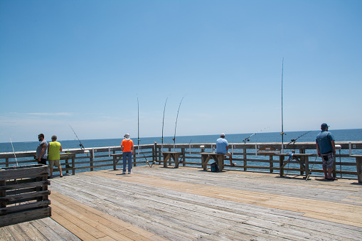 Myrtle Beach, United States - July 2nd, 2020: Fishermen on pier at the State Park in Myrtle Beach SC