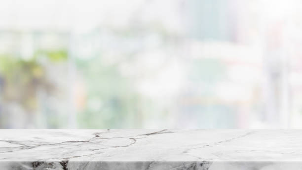 istock Empty white marble stone table top and blur glass window interior cafe and restaurant banner mock up abstract background - can used for display or montage your products. 1280991094