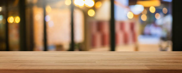istock Empty wood table top and blur glass window interior restaurant and cafe banner mock up background - can used for display or montage your products. 1280991098