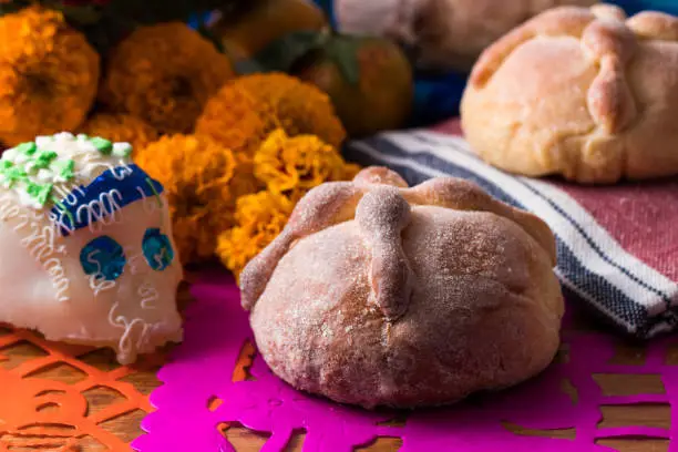 Day of the Dead Offering whit dead bread, sugar skull and cempasuchil flower