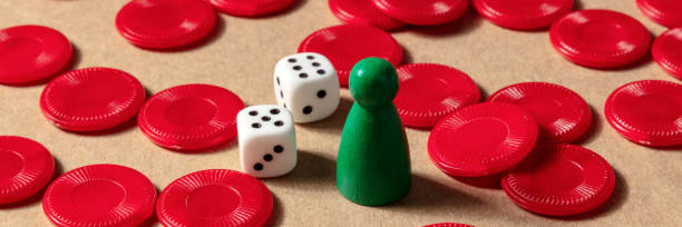 istock Board games panorama. A pawn with dice and red pieces 1280994060