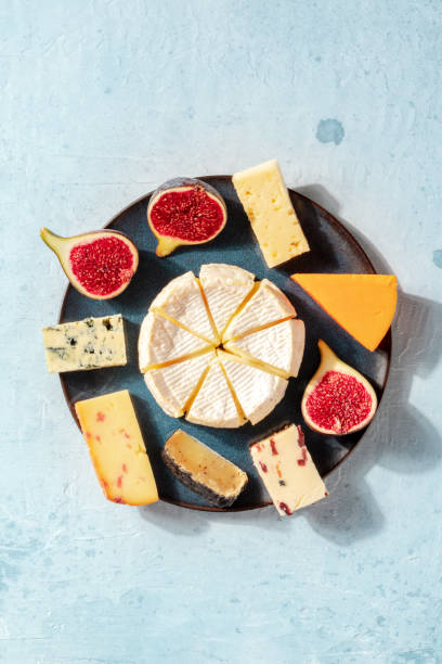 Cheese platter, shot from above, with copy space Cheese platter, shot from above, with copy space. An assortment of various cheeses plate fig blue cheese cheese stock pictures, royalty-free photos & images