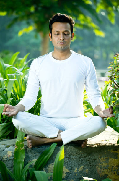 Mature man sitting at home and meditating.