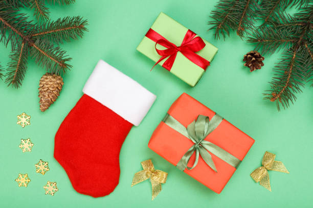 istock Santa's boot, gift box, fir tree branches with cones and christmas toys 1280997629