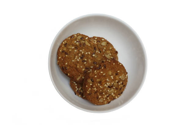istock Stack of oatmeal cookies with cereals in bowl on white background isolated 1280998867