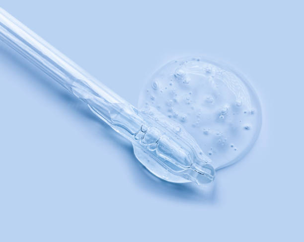 istock Liquid white cool blue gel or oil essence serum bubbles with pipettes on white and multi-colored isolated background 1281001008
