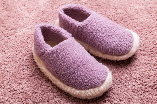 istock Woolen slippers stand on a pink carpet 1281001614