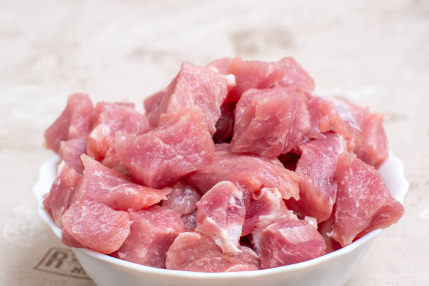 Close up sliced raw meat in a white bowl on a light table