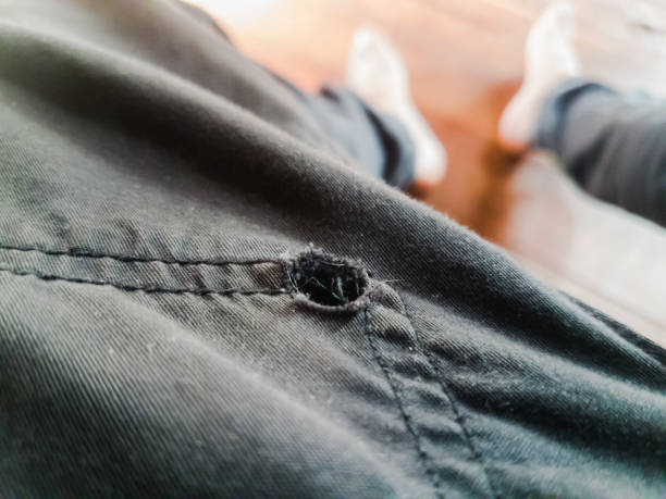 istock Black cloth pants are torn with holes. 1281002766