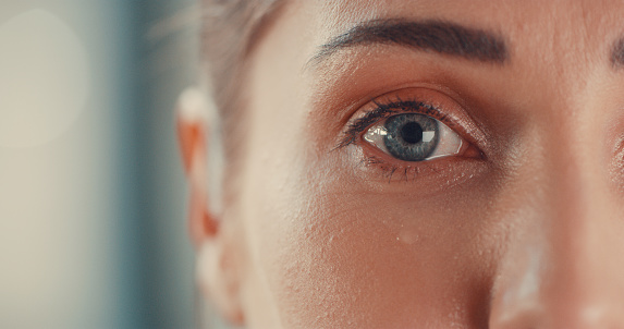 Portrait of a young woman’s eyes as she cries