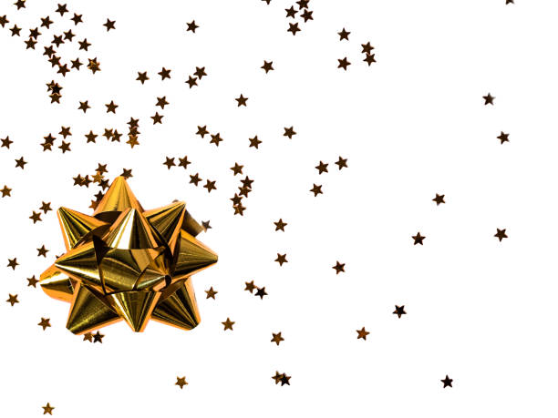 istock Gold bow with star glitter confetti on white background. 1281007514