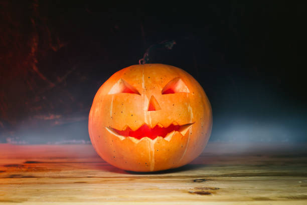 istock Pumpkin in the fog on a wooden table, Jack-o-lantern, 1281009184