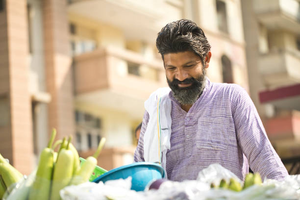 Indian market vendor selling vegetable on street cart