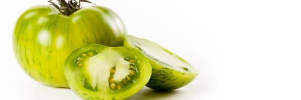 Food banner concept, organic vegetables and ingredients: close up of organic green tomatoes stock photo
