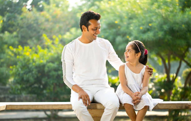 istock Playful father and daughter at park 1281009856