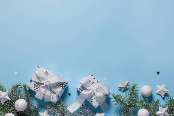 istock Christmas background with gift boxes, xmas tree and stars on blue with copy space 1281010445