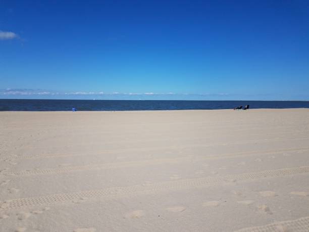 istock tire tracks and foot prints on combed beach and sea water 1281010629