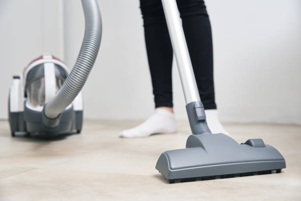 istock Woman use vacuum cleaner at the floor 1281011200