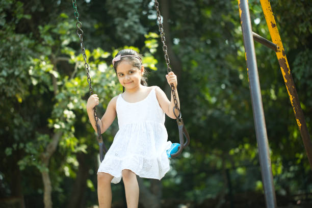 istock Little girl on amusement park swing 1281011873