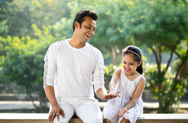 istock Playful father and daughter at park 1281012203