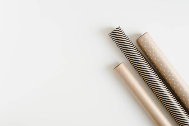 istock Three gift wrapping paper rolls on white background, top view. Kraft paper for DIY Christmas gift wrapping. Eco friendly packaging 1281012214