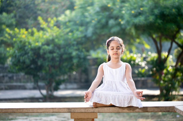 istock Little girl meditating outdoors at park 1281012577