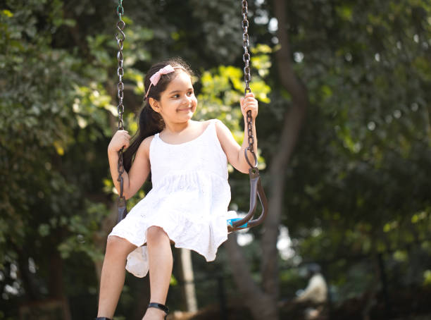 Little girl on amusement park swing