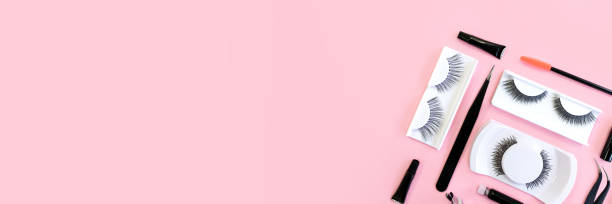 istock Different tools for eye lash extension on trendy pastel pink background. Fake eyelashes and tweezers. Knolling concept. Makeup cosmetics. Top view, copy space. Place for text and design. Banner. 1281012644