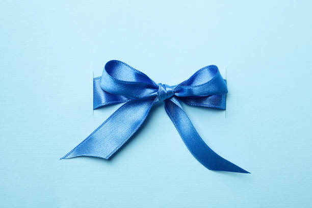 istock Blue gift bow on blue background, close up 1281013717