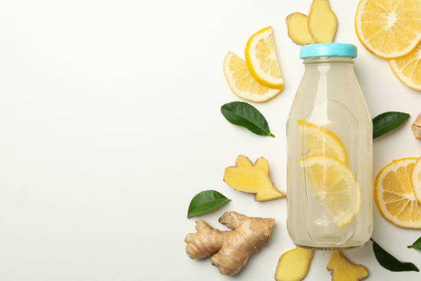 istock Bottle of ginger lemon water on white background 1281014756