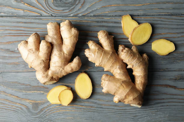 istock Fresh ginger on wooden background, top view 1281015123