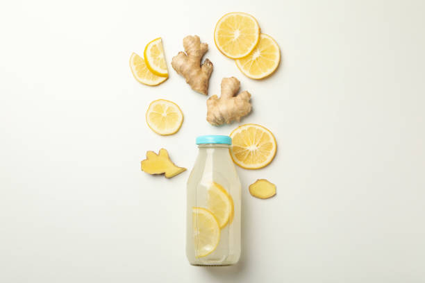 istock Bottle of ginger lemon water on white background 1281015891