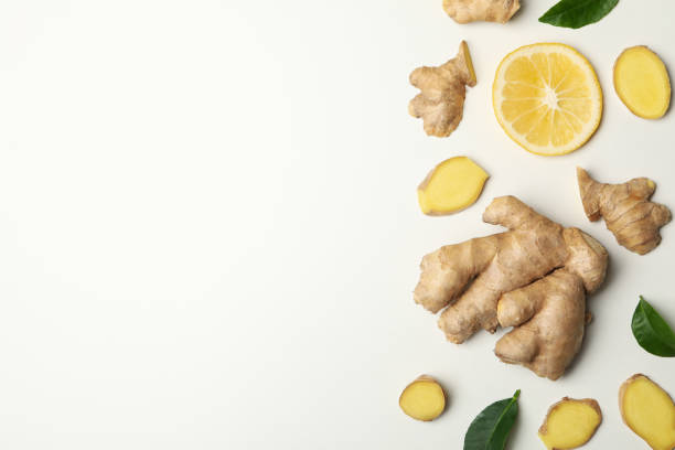 istock Fresh ginger and lemon on white background, top view 1281016187