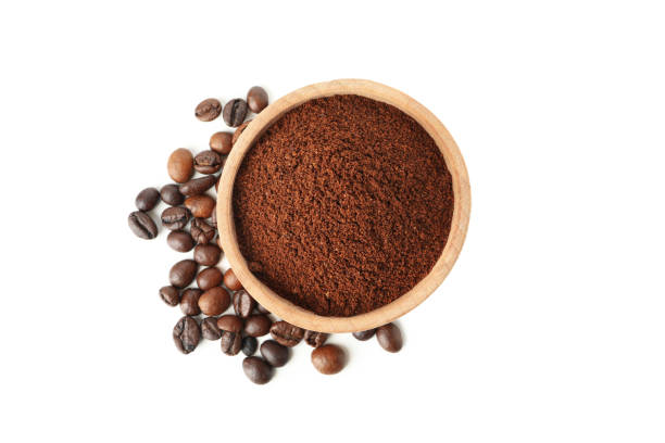 istock Wooden bowl with ground coffee isolated on white background 1281017285