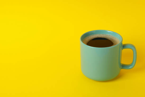istock Cup of coffee on yellow background, space for text 1281017867