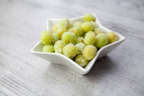 istock Sour candy grapes in star shaped bowl on wood surface 1281018089