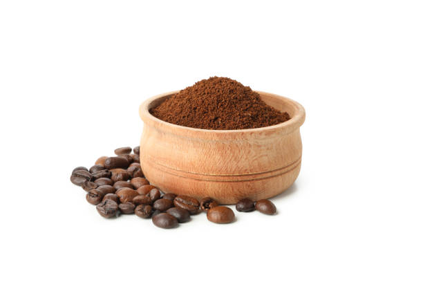 istock Wooden bowl with ground coffee isolated on white background 1281018135