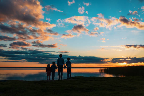 istock happy father with kids at sunset beach 1281018154