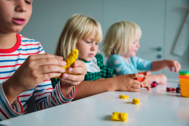 istock Child play with clay molding shapes during online lesson 1281018687