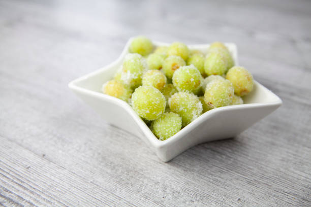 istock Sour candy grapes in star shaped bowl on wood surface 1281018691