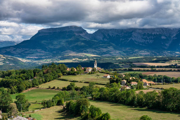 Trieves valley with the Vercors mountain range near Bourg Saint Maurice, France Scenic view on the Trieves valley with the Vercors mountain range near Bourg Saint Maurice village from the top of the Menil mountain, Rhone-Alpes, France drome stock pictures, royalty-free photos & images