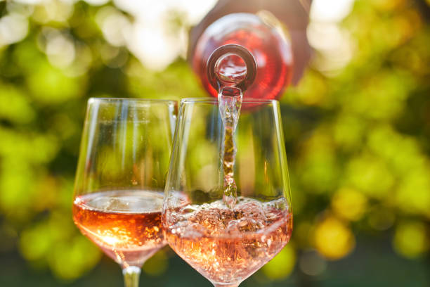 pouring rose wine into a glass - winetasting imagens e fotografias de stock