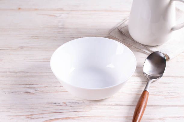 istock Empty white bowl on white wooden background 1281019234